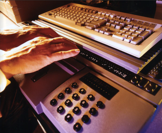 photo of user typing on braille keyboard