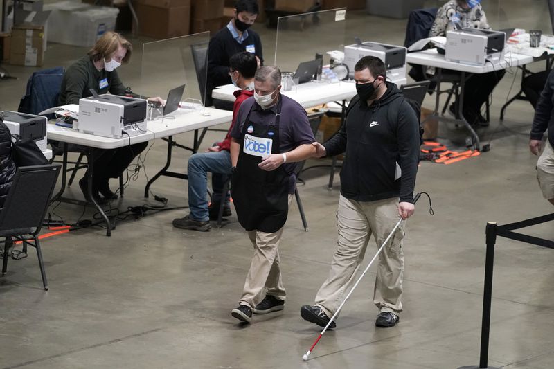 photo man with sight disability walking in a voting facility