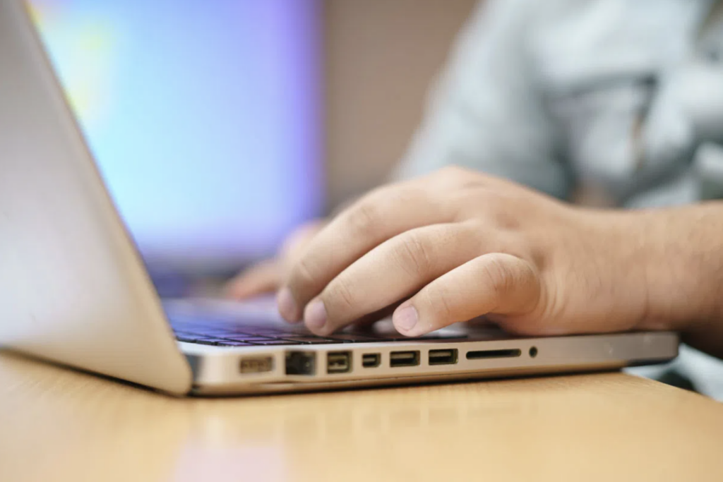 Person's hands using a laptop