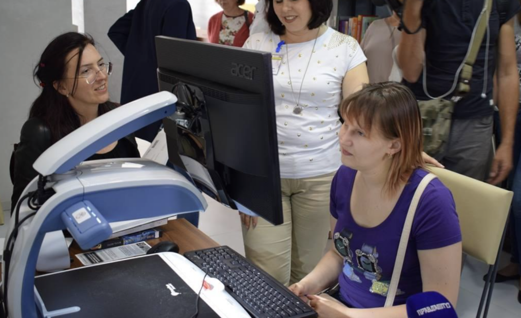 Daria Korzhavina (right, sitting at computer) tests out a website adapted for the visually impaired.