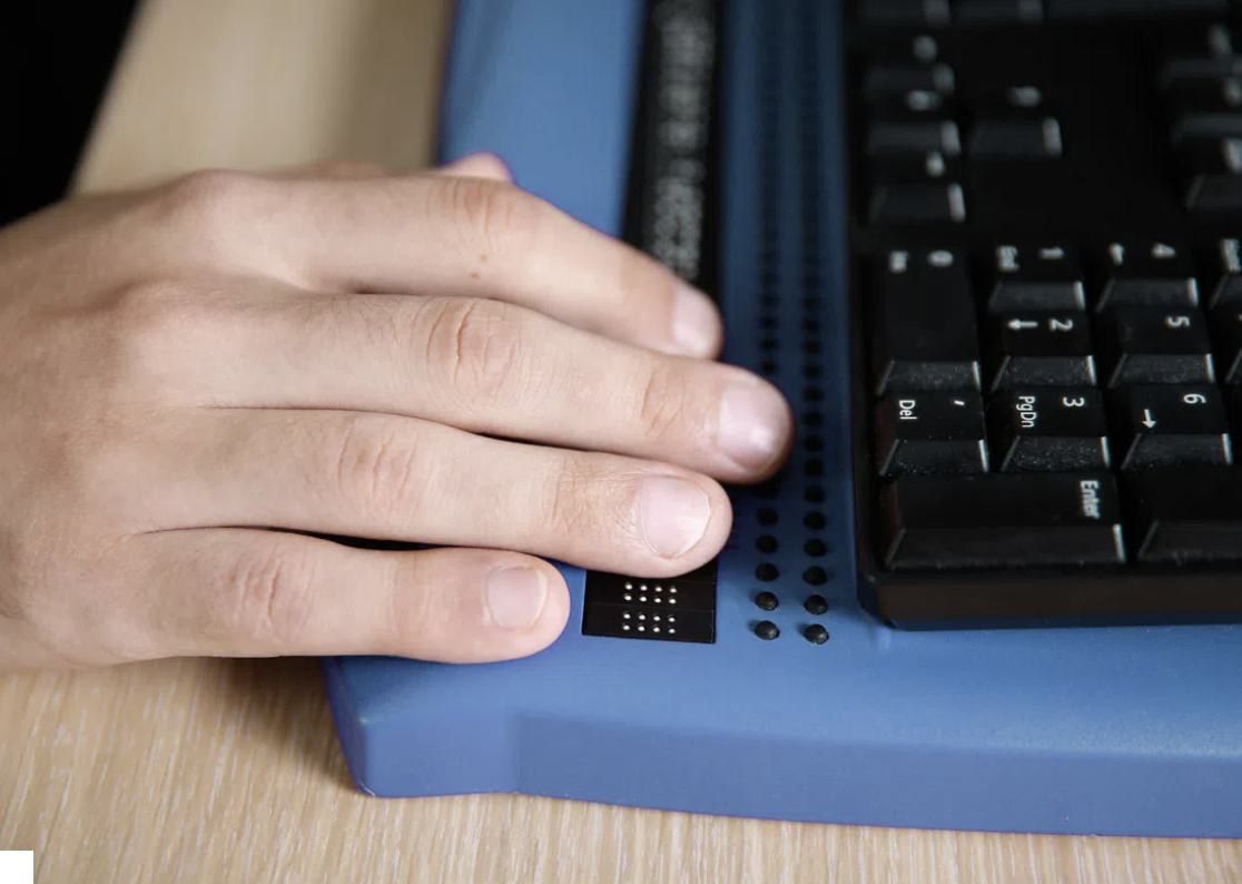 photo of hands using braille keyboard