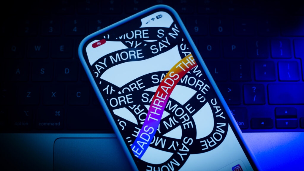smartphone illustration showing "threads" and "say more" on the screen